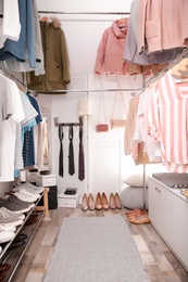 Modern dressing room with different stylish clothes and accessories