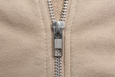 Photo of Beige sweatshirt with zipper as background, top view