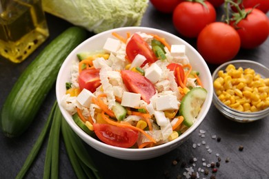 Photo of Tasty salad with Chinese cabbage served on black table