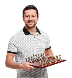 Photo of Handsome man holding chessboard with game pieces on white background
