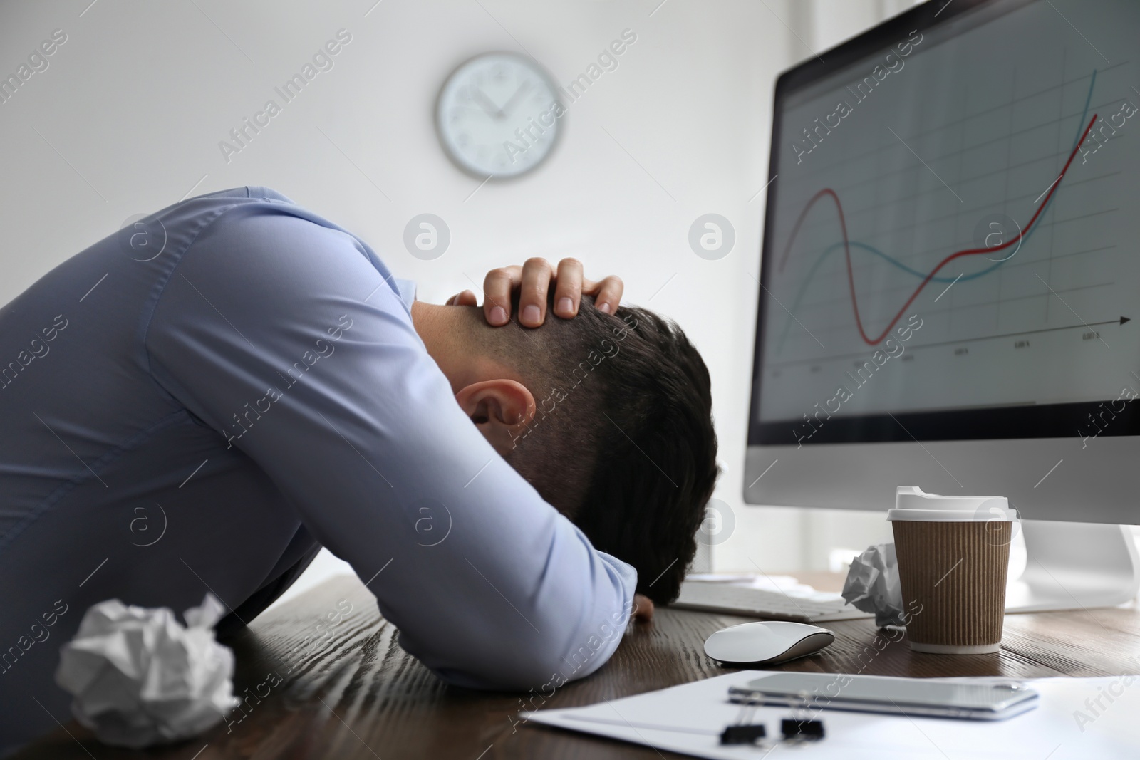 Photo of Stressed out businessman at workplace in office
