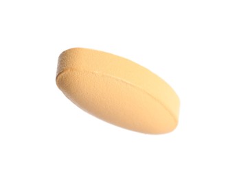 Photo of One pale orange pill isolated on white
