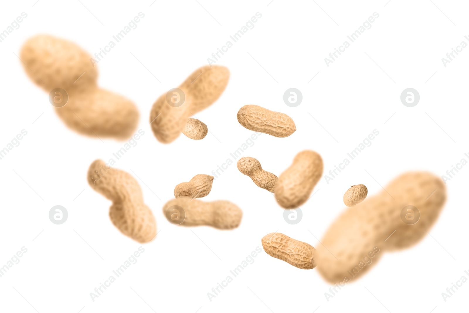 Image of Unpeeled peanuts in air on white background