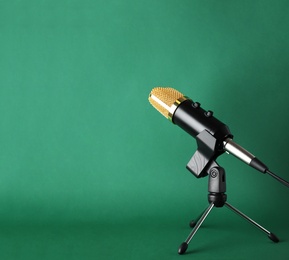 Photo of Condenser microphone on color background, space for text