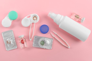 Photo of Flat lay composition with color contact lenses on pink background