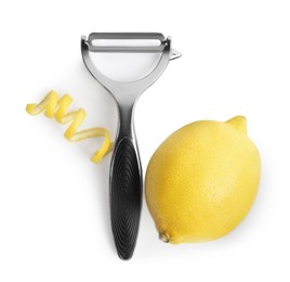 Peeler, fresh lemon and zest on white background, top view
