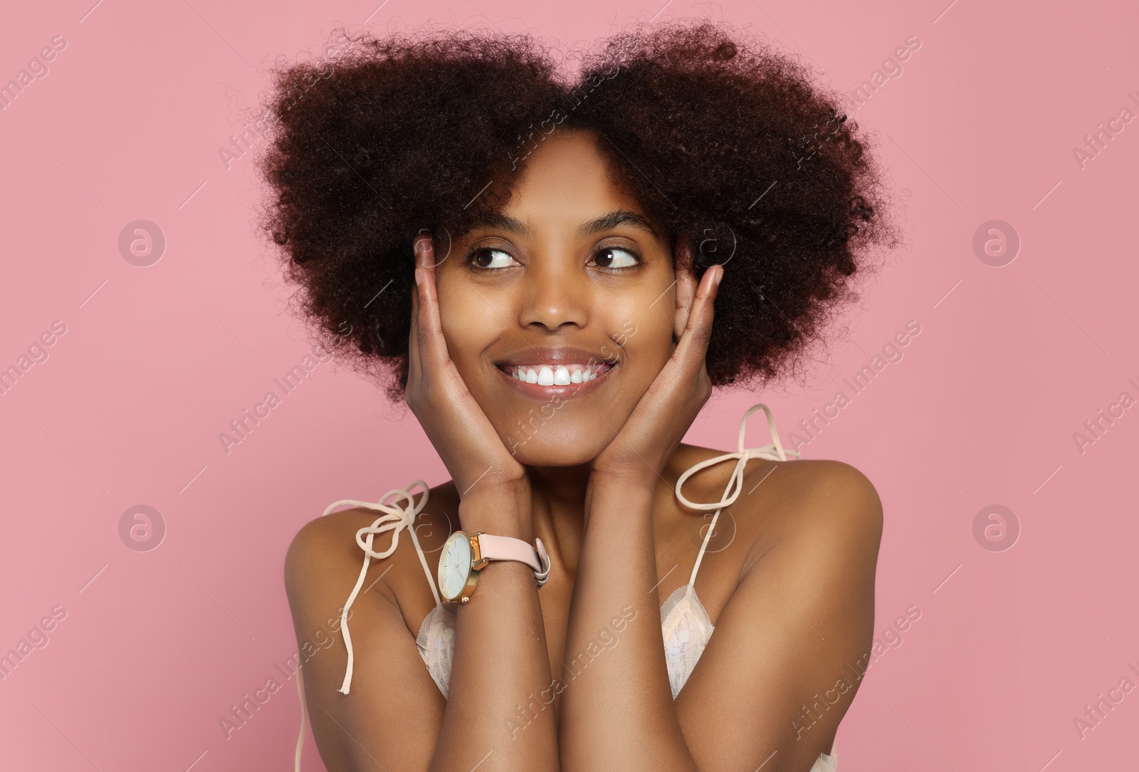 Photo of Portrait of smiling African American woman on pink background