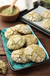 Many tasty matcha cookies on wooden table