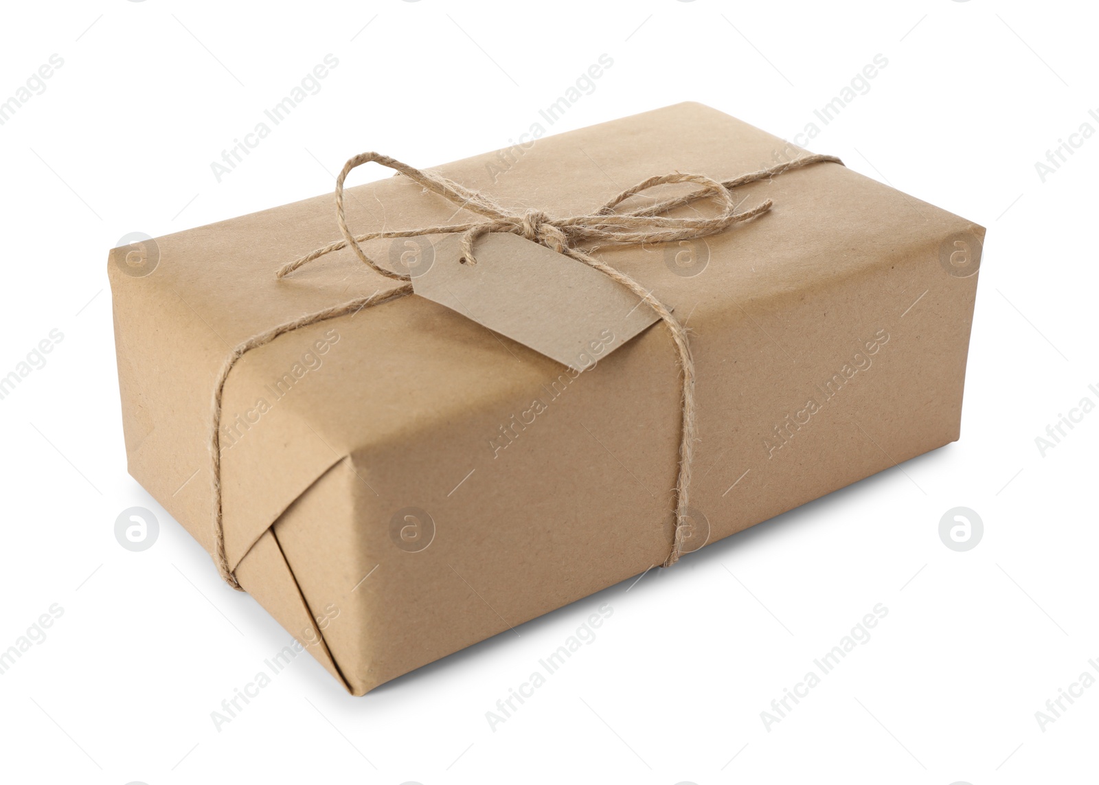 Photo of Parcel wrapped in kraft paper with tag on white background