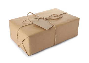 Photo of Parcel wrapped in kraft paper with tag on white background