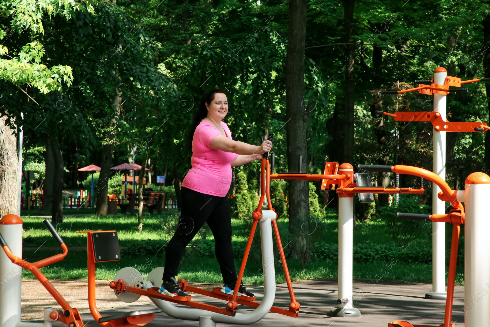 Photo of Overweight woman doing exercise with air walker in park