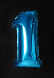 Photo of Blue number one balloon on black background