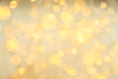 Photo of Gold glitter with bokeh effect on light background