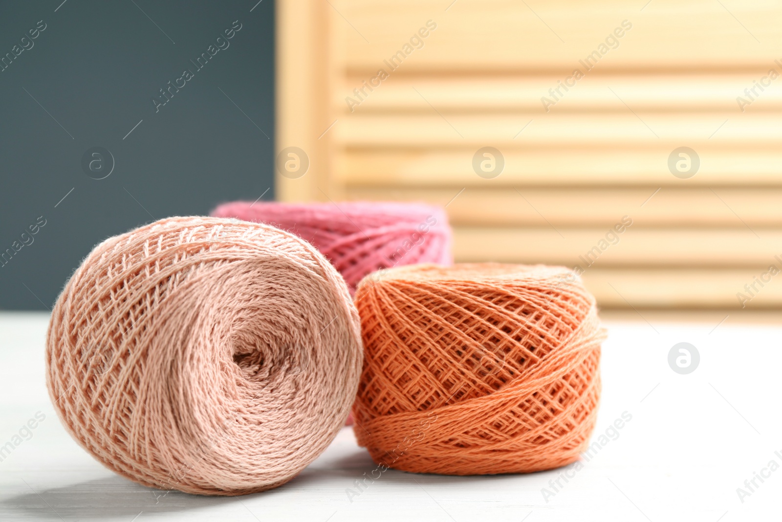 Photo of Clews of knitting threads on table, space for text. Sewing stuff