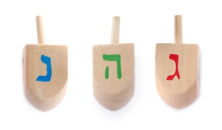 Image of Hanukkah traditional dreidels with letters on white background, collage 