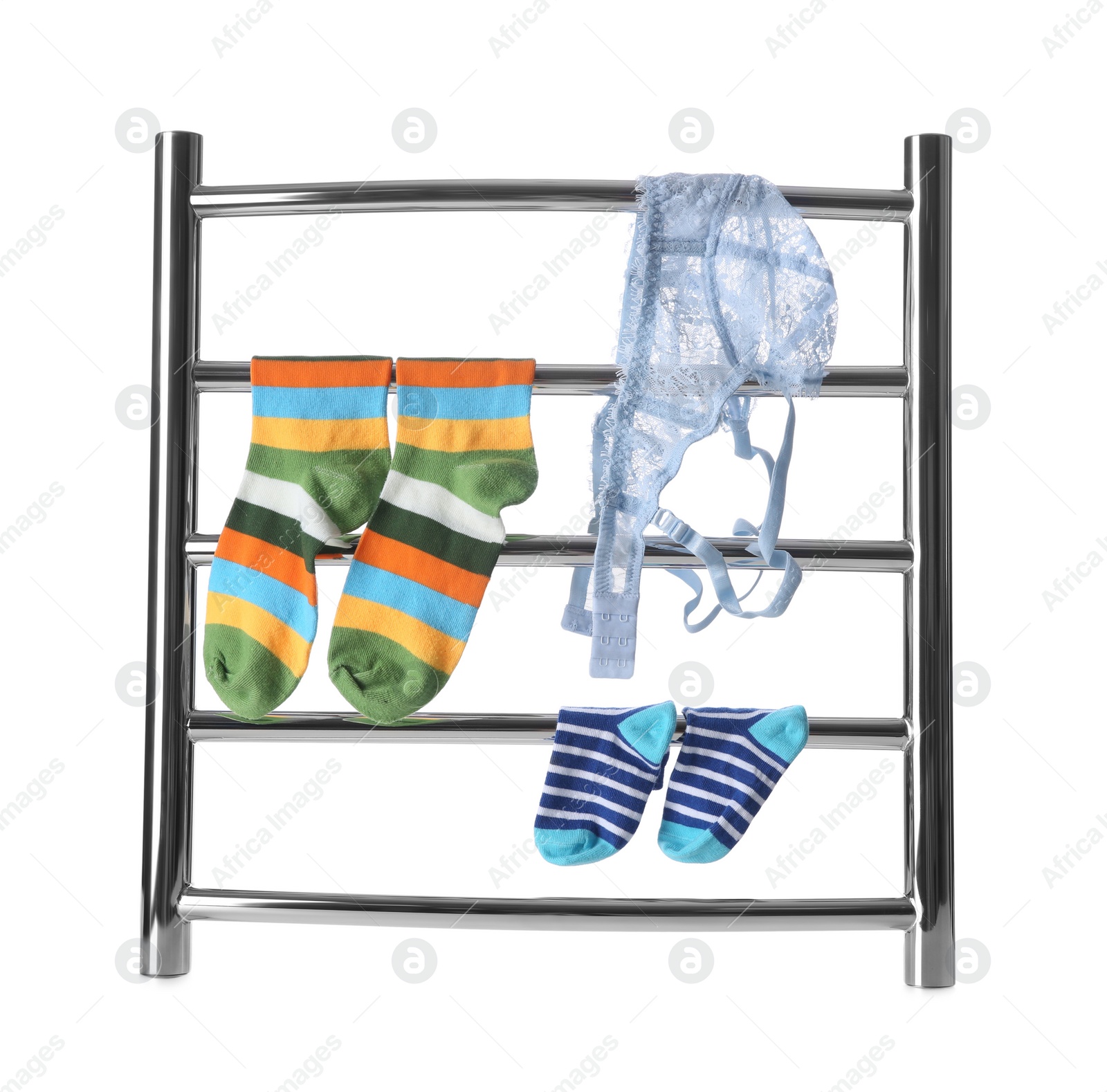 Photo of Modern heated towel rail with socks and underwear isolated on white