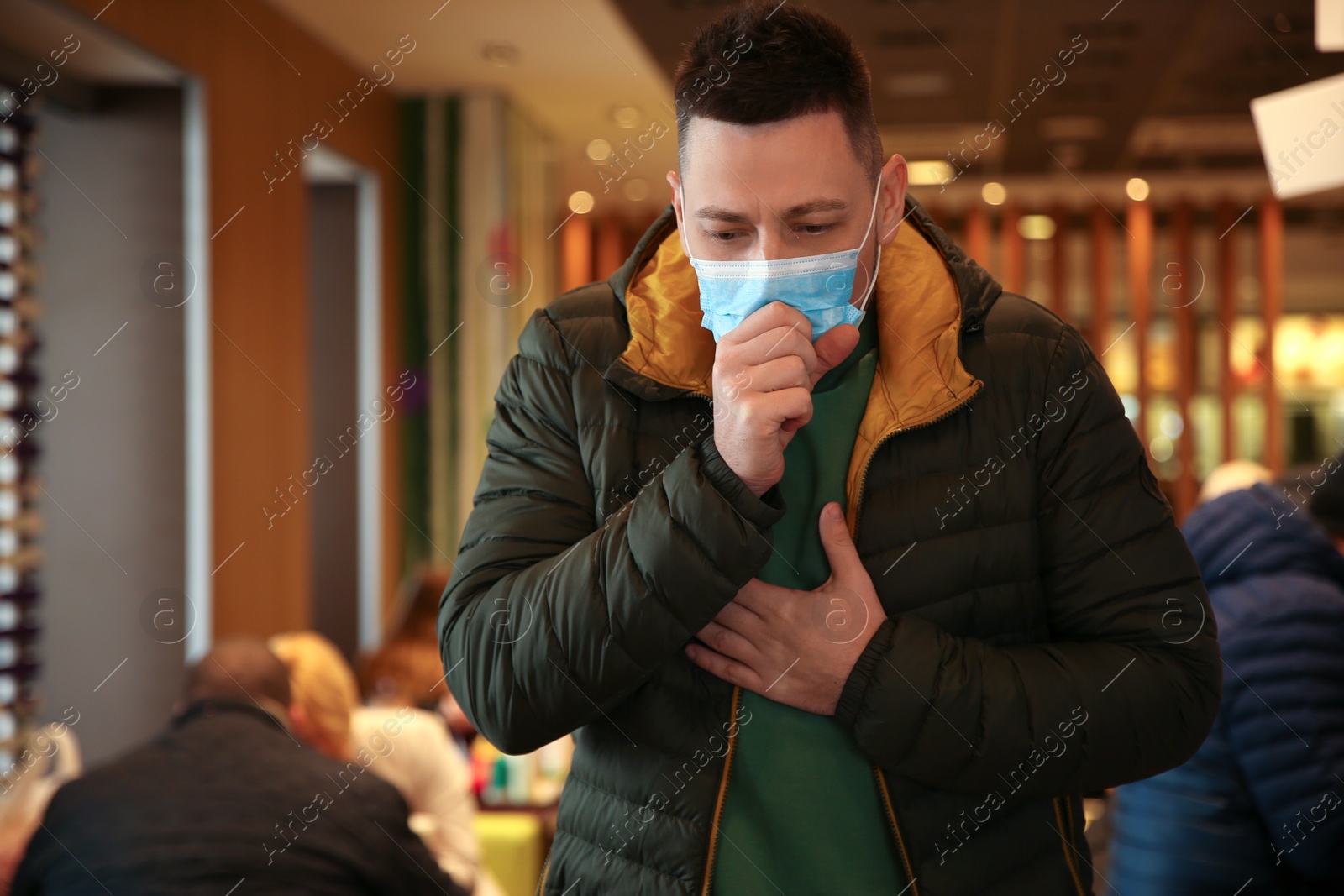 Photo of Man with disposable mask in cafe. Virus protection