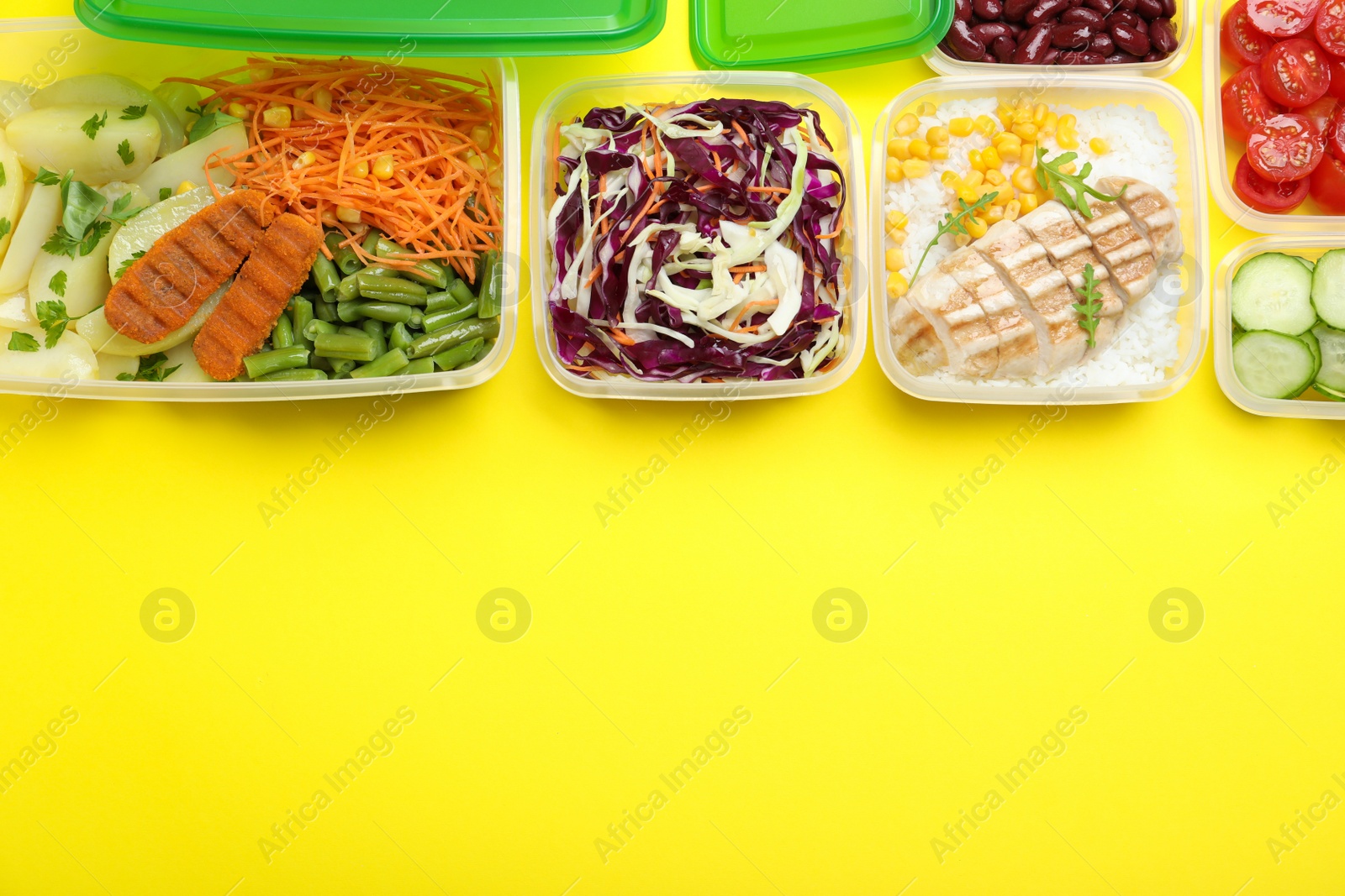 Photo of Set of plastic containers with fresh food on yellow background, flat lay. Space for text