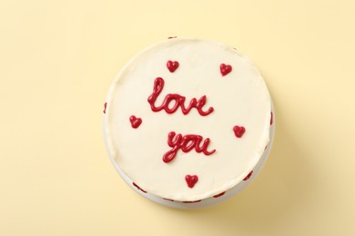 Bento cake with text Love You on beige table, top view. St. Valentine's day surprise