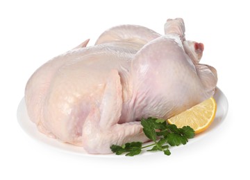 Photo of Fresh raw chicken with lemon and parsley isolated on white