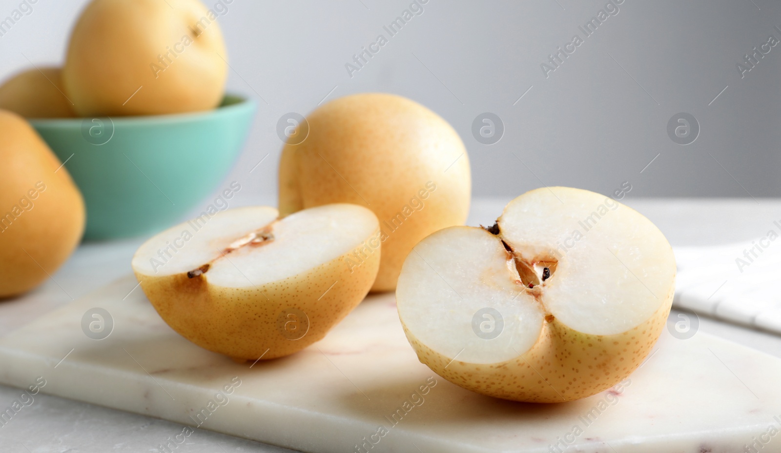 Photo of Cut and whole apple pears on table