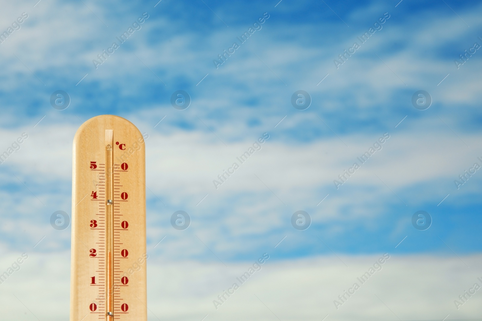 Photo of Weather thermometer and blue cloudy sky on background. Space for text