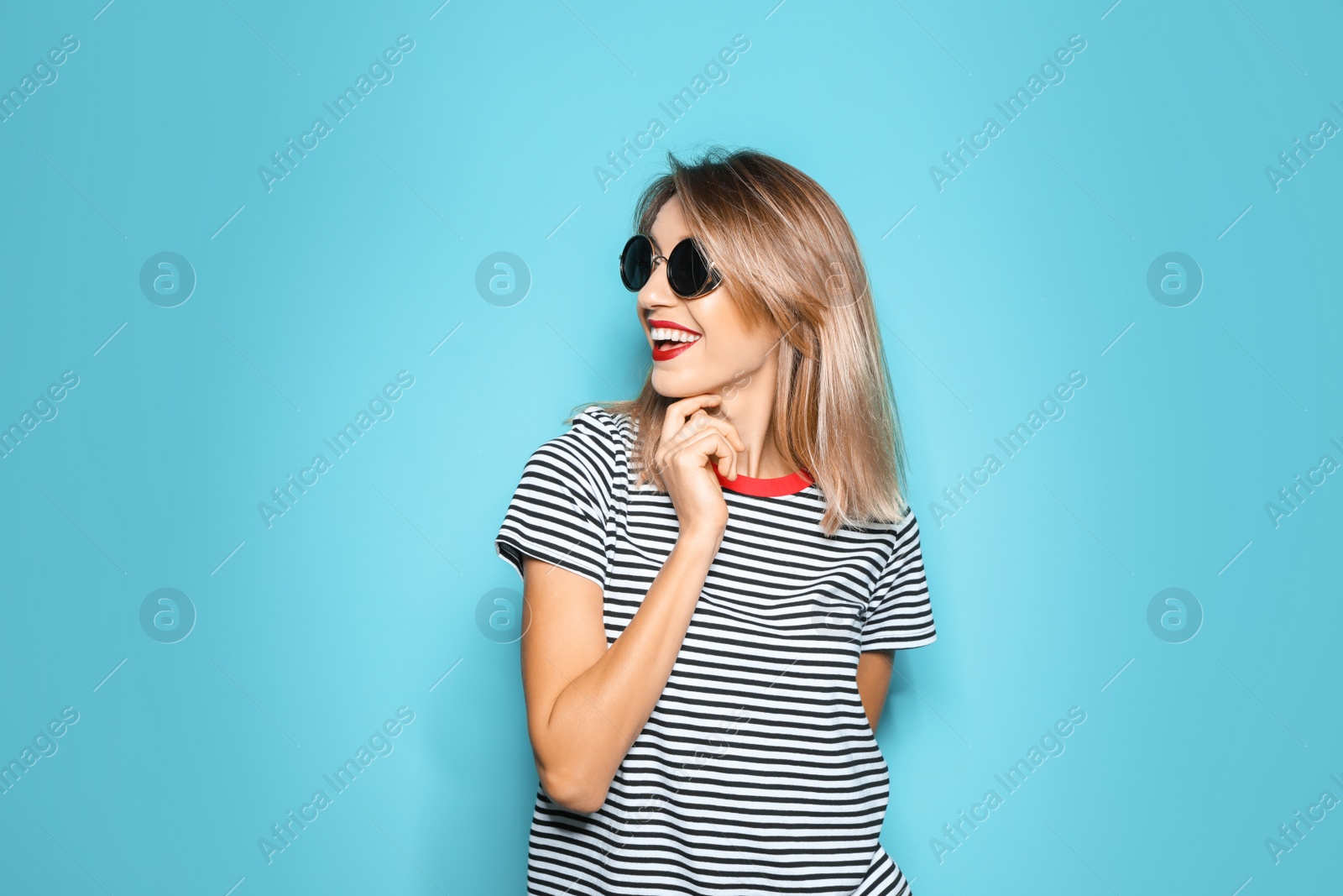 Photo of Beautiful young woman with healthy long blonde hair on color background