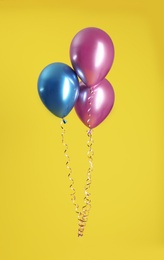 Bunch of bright balloons on color background