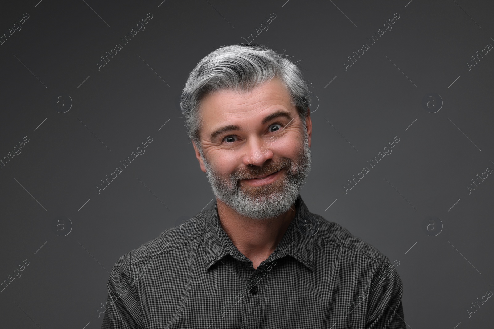 Photo of Personality concept. Portrait of bearded man on dark grey background