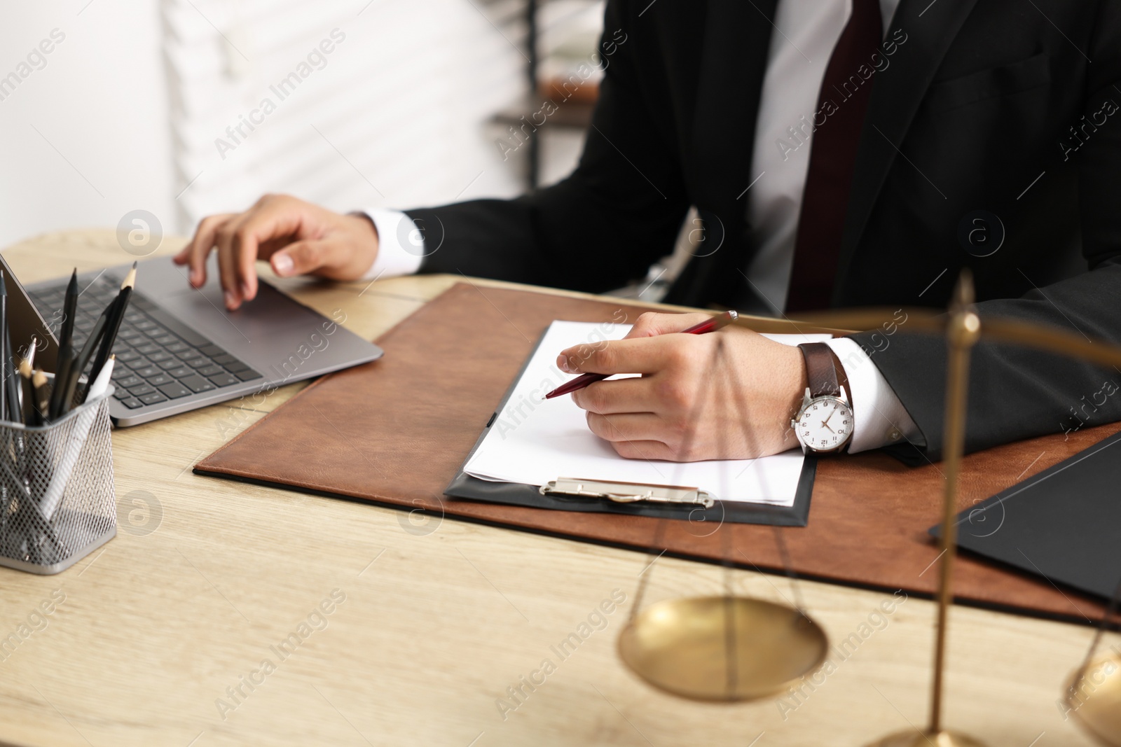 Photo of Lawyer working at table in office, closeup