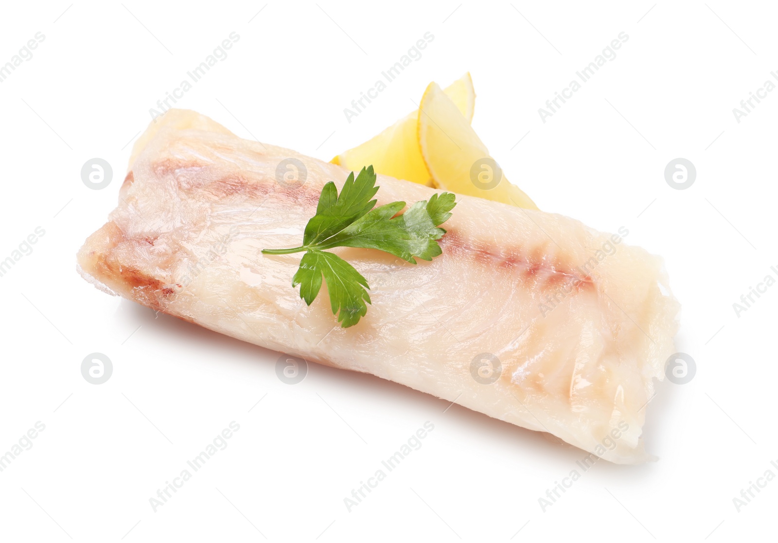 Photo of Pieces of raw cod fish, parsley and lemon isolated on white