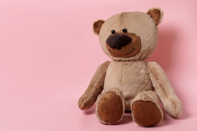 Cute teddy bear on pink background, space for text