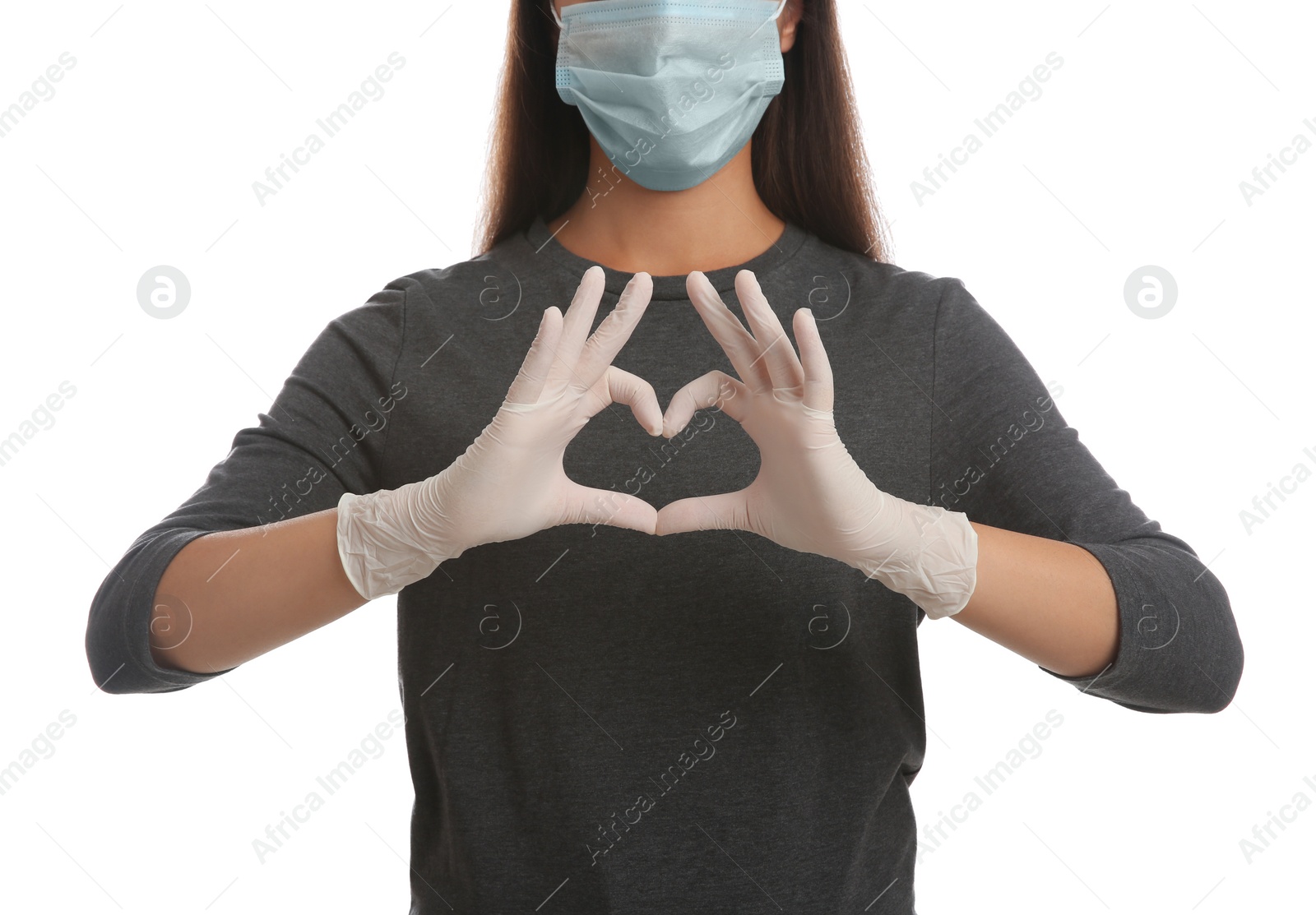 Photo of Woman in protective face mask and medical gloves making heart with hands on white background, closeup