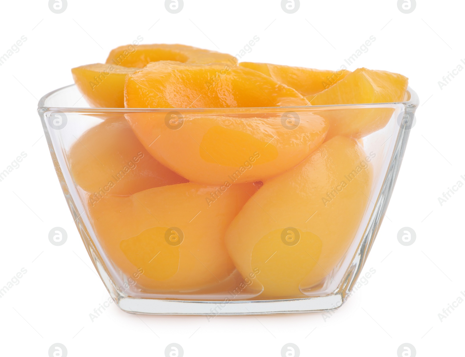 Photo of Halves of canned peaches in bowl isolated on white