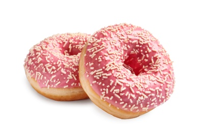 Delicious glazed doughnuts with sprinkles on white background