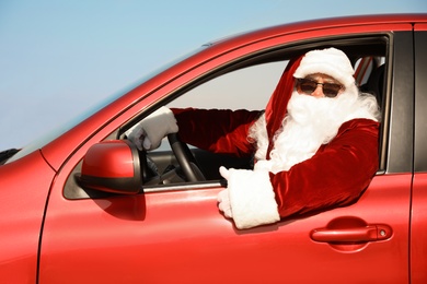 Photo of Authentic Santa Claus driving modern car outdoors