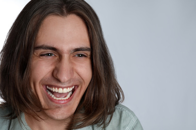 Photo of Portrait of happy young man on white background, closeup