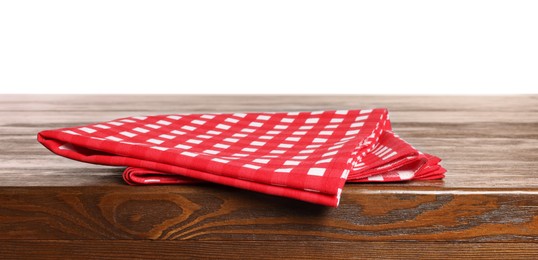 Photo of Checkered tablecloth on wooden table against white background