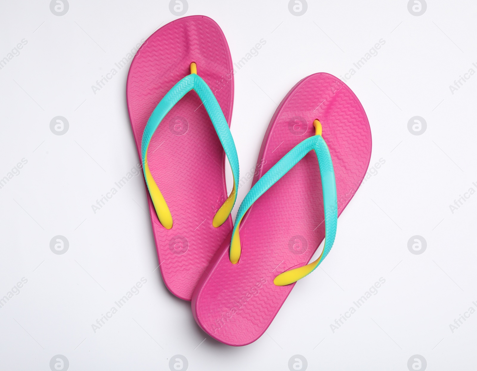 Photo of Pair of flip flops on white background, top view. Beach accessories