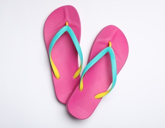 Photo of Pair of flip flops on white background, top view. Beach accessories