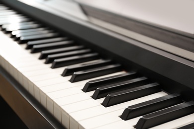 Photo of Modern piano with black and white keys, closeup