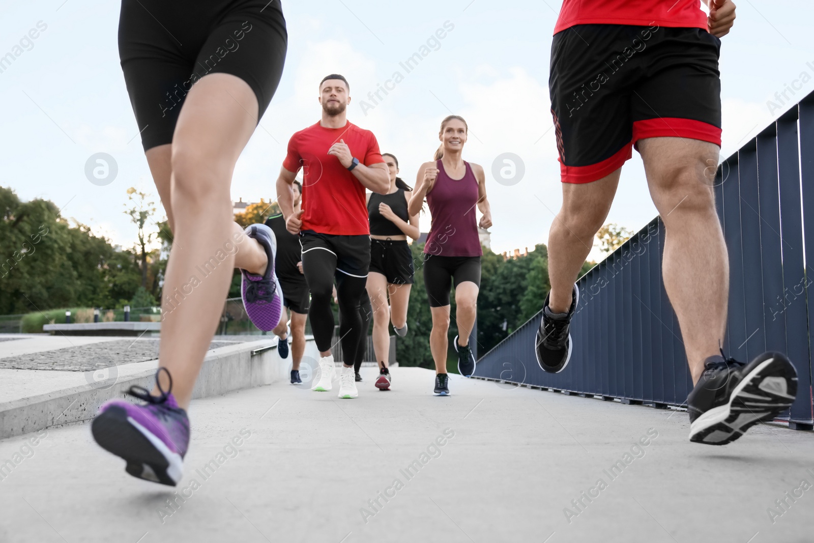 Photo of Group of people running outdoors. Active lifestyle