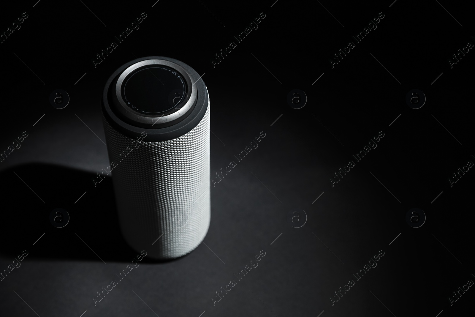 Photo of One portable bluetooth speaker on black background, space for text. Audio equipment