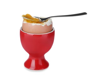 Cup with fresh soft boiled egg and spoon on white background