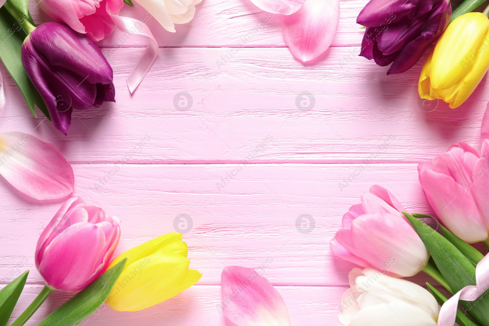 Photo of Flat lay composition of beautiful spring tulips on wooden background, space for text. International Women's Day