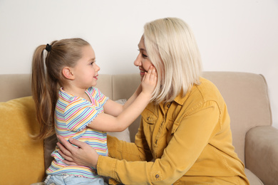 Mature woman with her little granddaughter at home