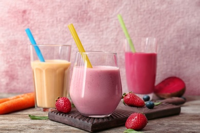 Glasses with healthy detox smoothies and ingredients on table