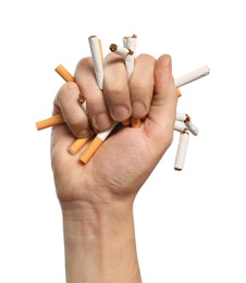 Photo of Stop smoking. Man holding broken cigarettes on white background, closeup