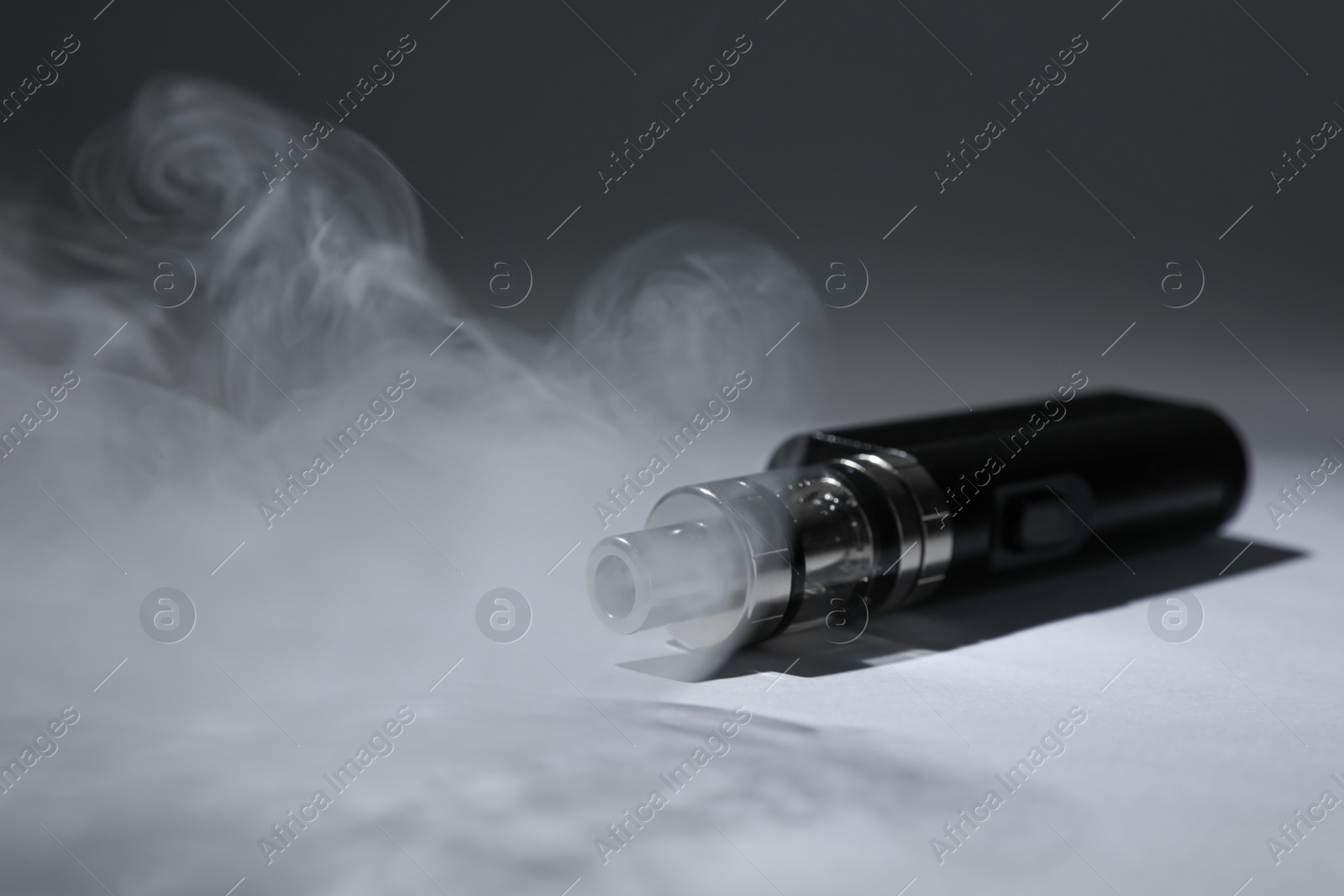 Photo of Electronic cigarette and smoke on grey background, space for text