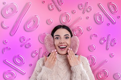 Image of Discount offer. Happy woman wearing earmuffs on pink background. Percent signs falling behind her